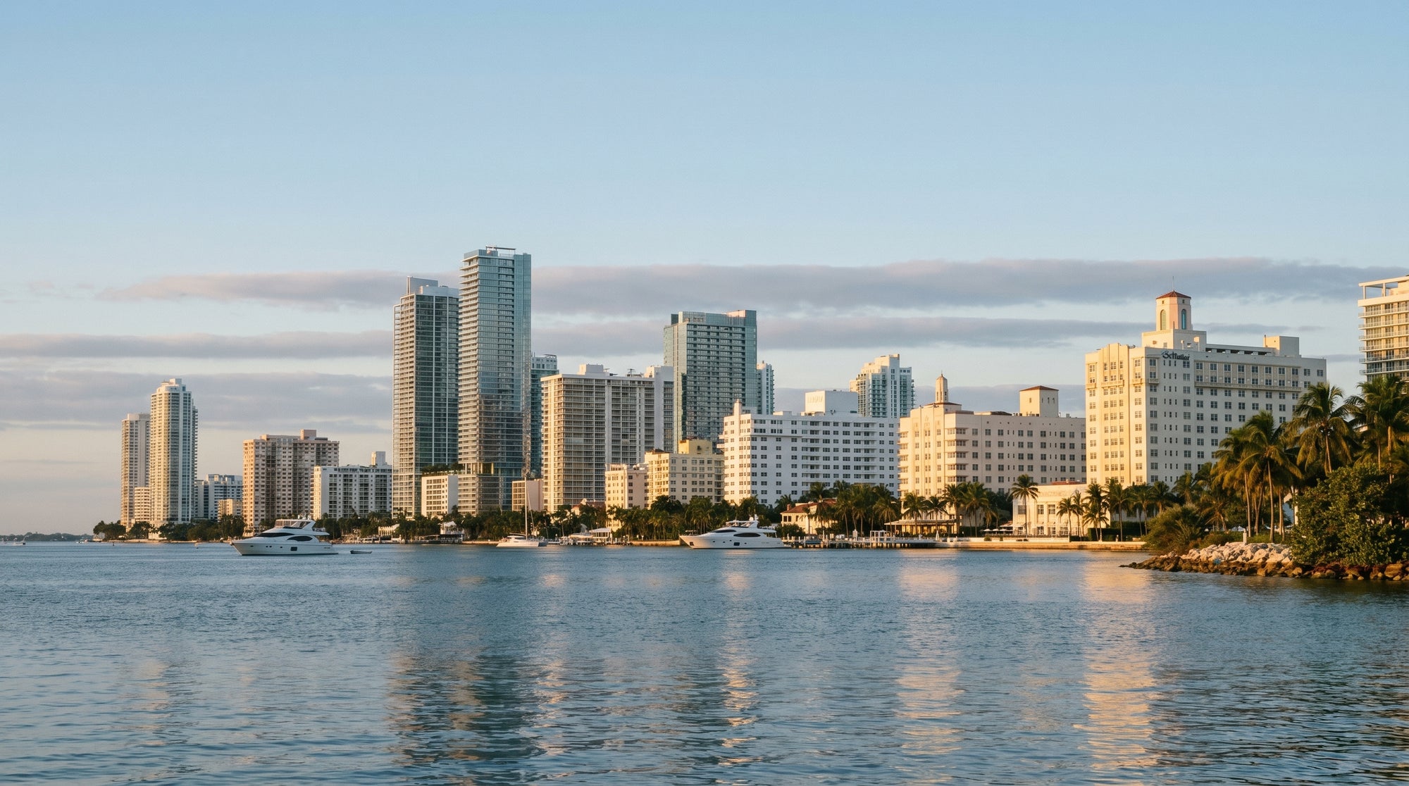 City skyline with modern buildings reflected in water, clear sky